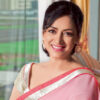 Anuradha Patel smiling for the camera